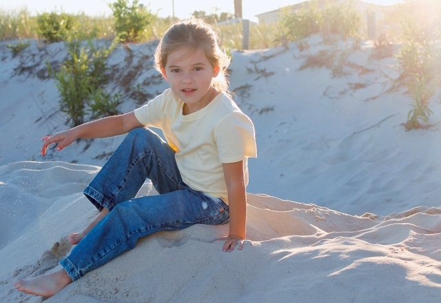 A young fan takes in the tournament from the dune