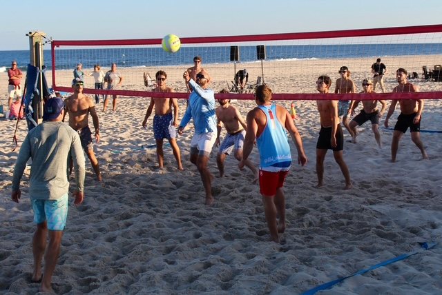 Teams rally at the net at the Summer Send-Off Volleyball Tournament