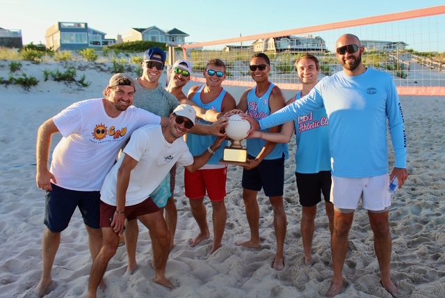 The winning team celebrates with the trophy